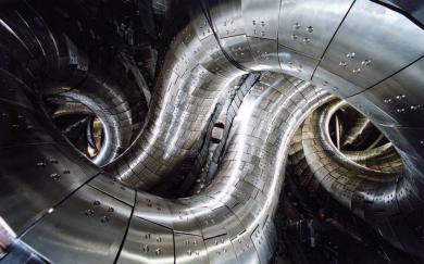 Interior of the Large Helical Device (LHD), showing the strongly twisted plasma vessel characteristic of helical stellarator geometry. (Credit: Wikimedia Commons) Interior of the Large Helical Device (LHD), showing the strongly twisted plasma vessel characteristic of helical stellarator geometry. (Credit: Wikimedia Commons)